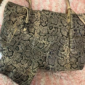 Snakeskins dialed tote with a pouch to match. New without tags.